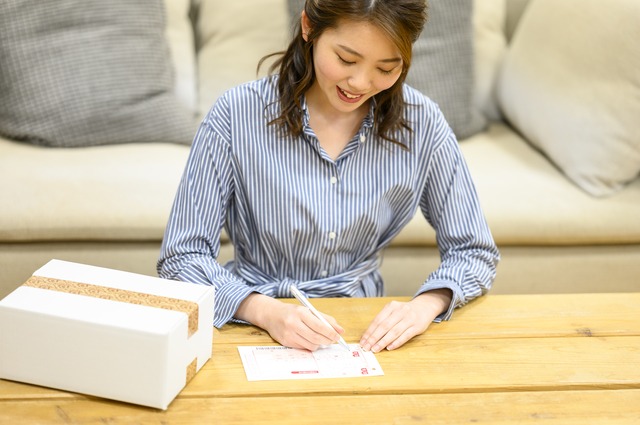 配送伝票を書く女性